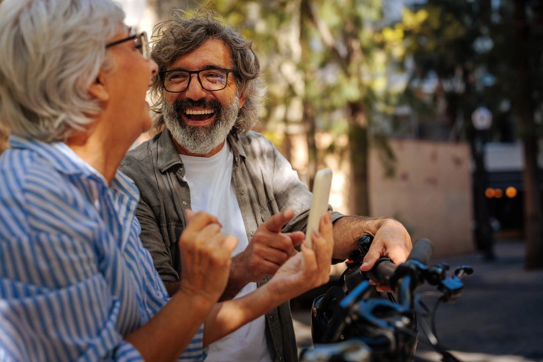Two people talking and laughing outdoors